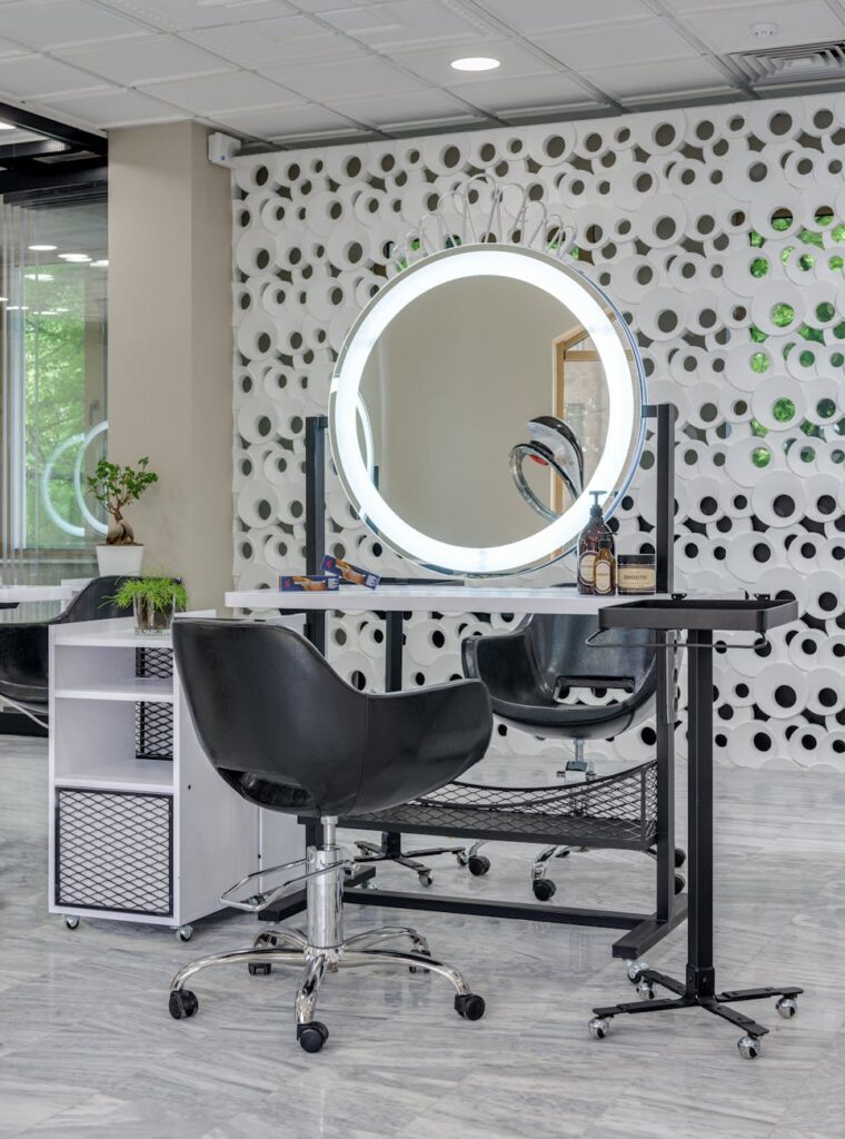 black vanity chair near round vanity mirror