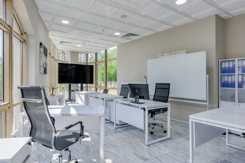 white desks and swivel chairs in the office